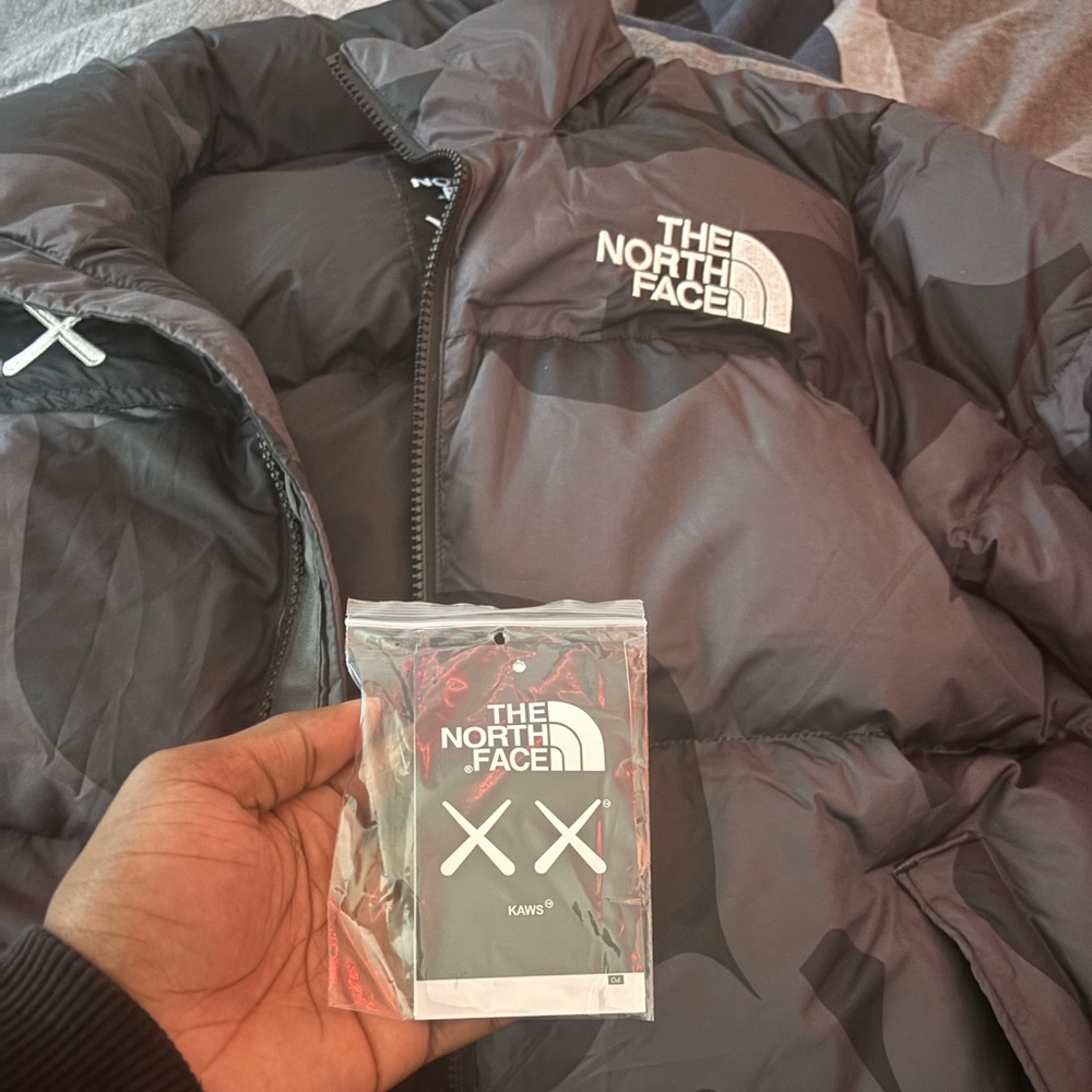 North face Kaws puffer fits a medium and a small